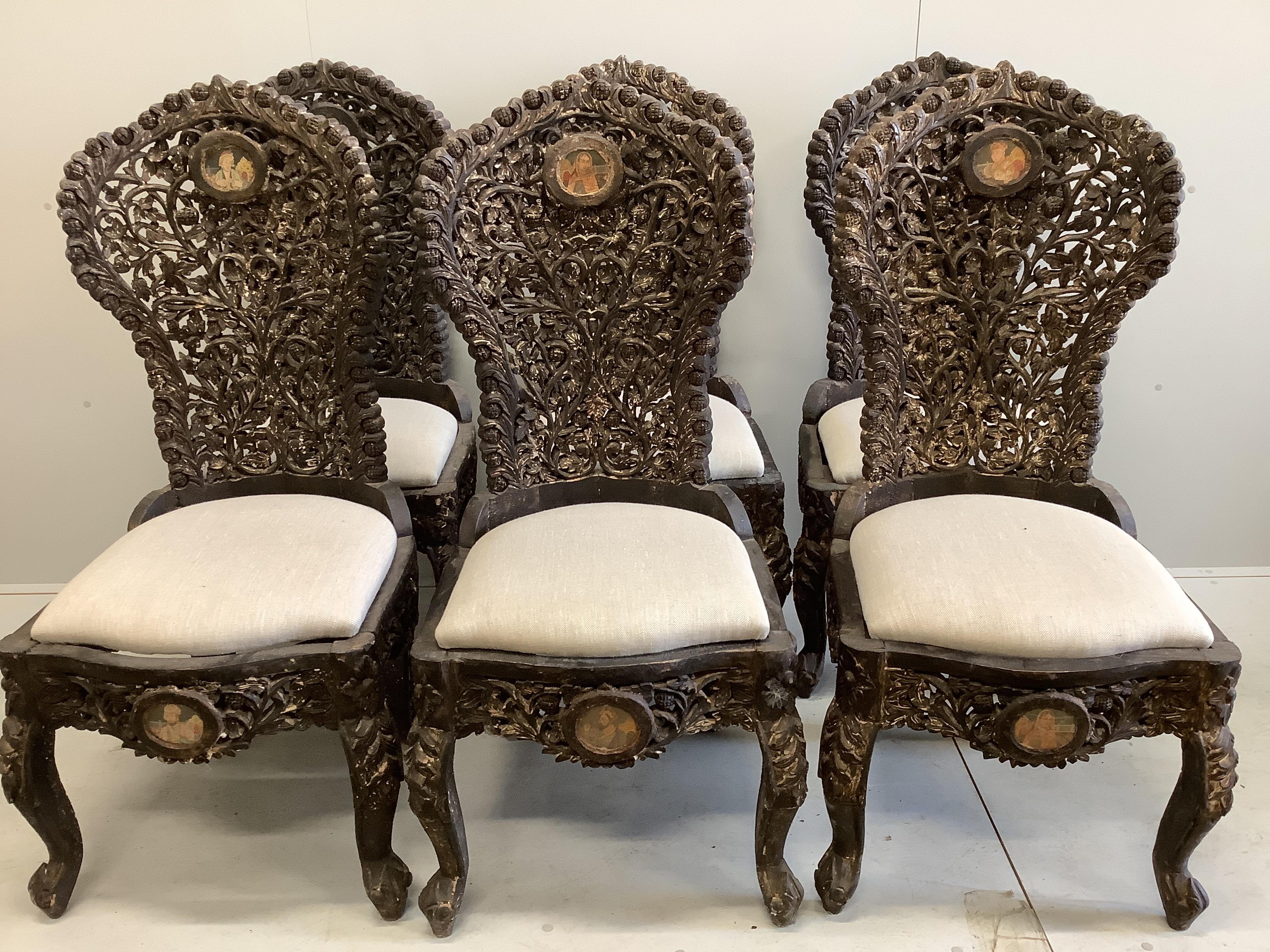 A set of six Indian carved hardwood chairs inset circular portrait plaques, width 48cm, depth 52cm, height 118cm